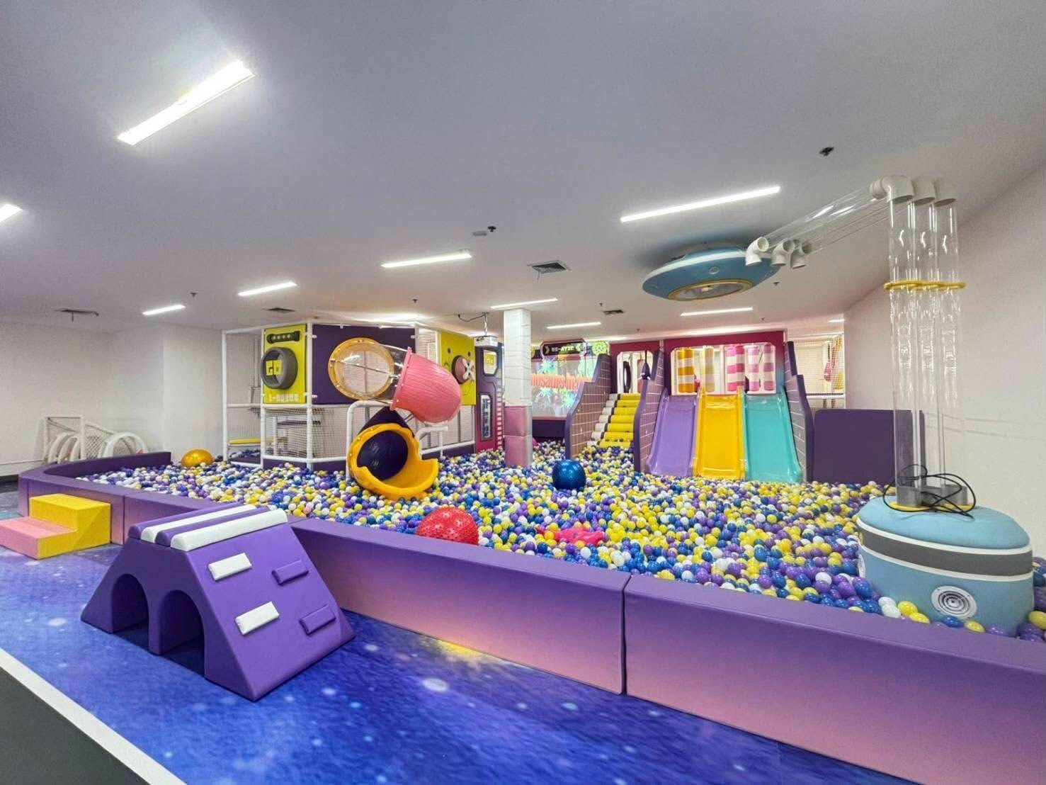 Kids playing in the KidTopia ball pit and slides